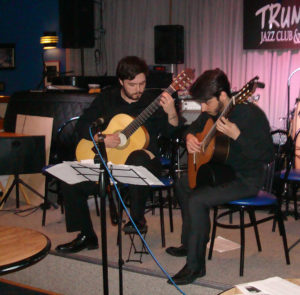 2 Young Men Playing Guitar On Stage At Trumpets Jazz Club And Restaurant