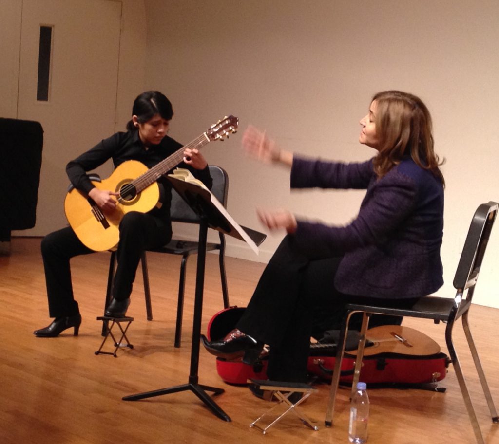 Young Female Guitarist Studying