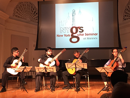 4 guitarists playing on stage